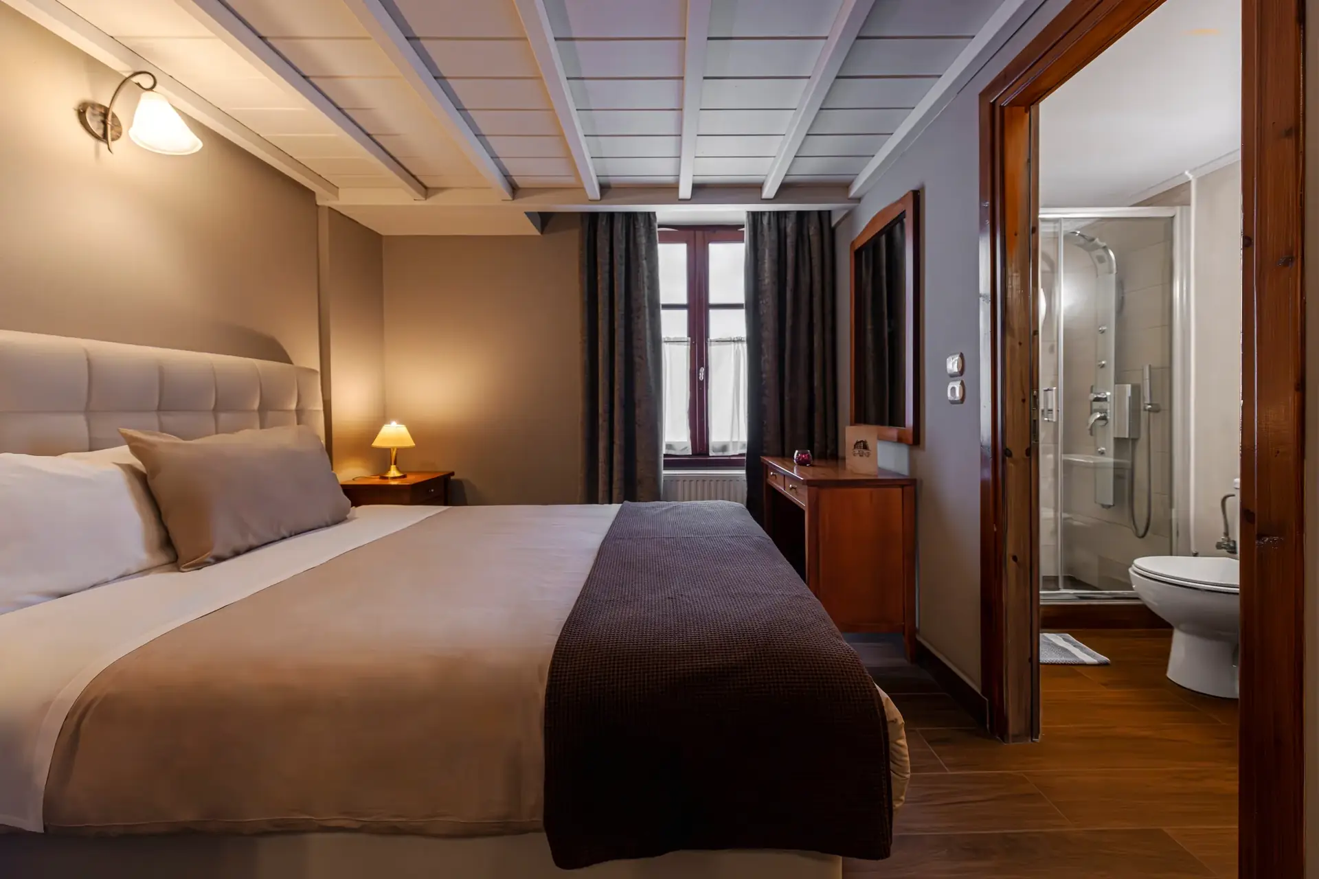Bedroom with wooden furniture and adjoining bathroom with shower