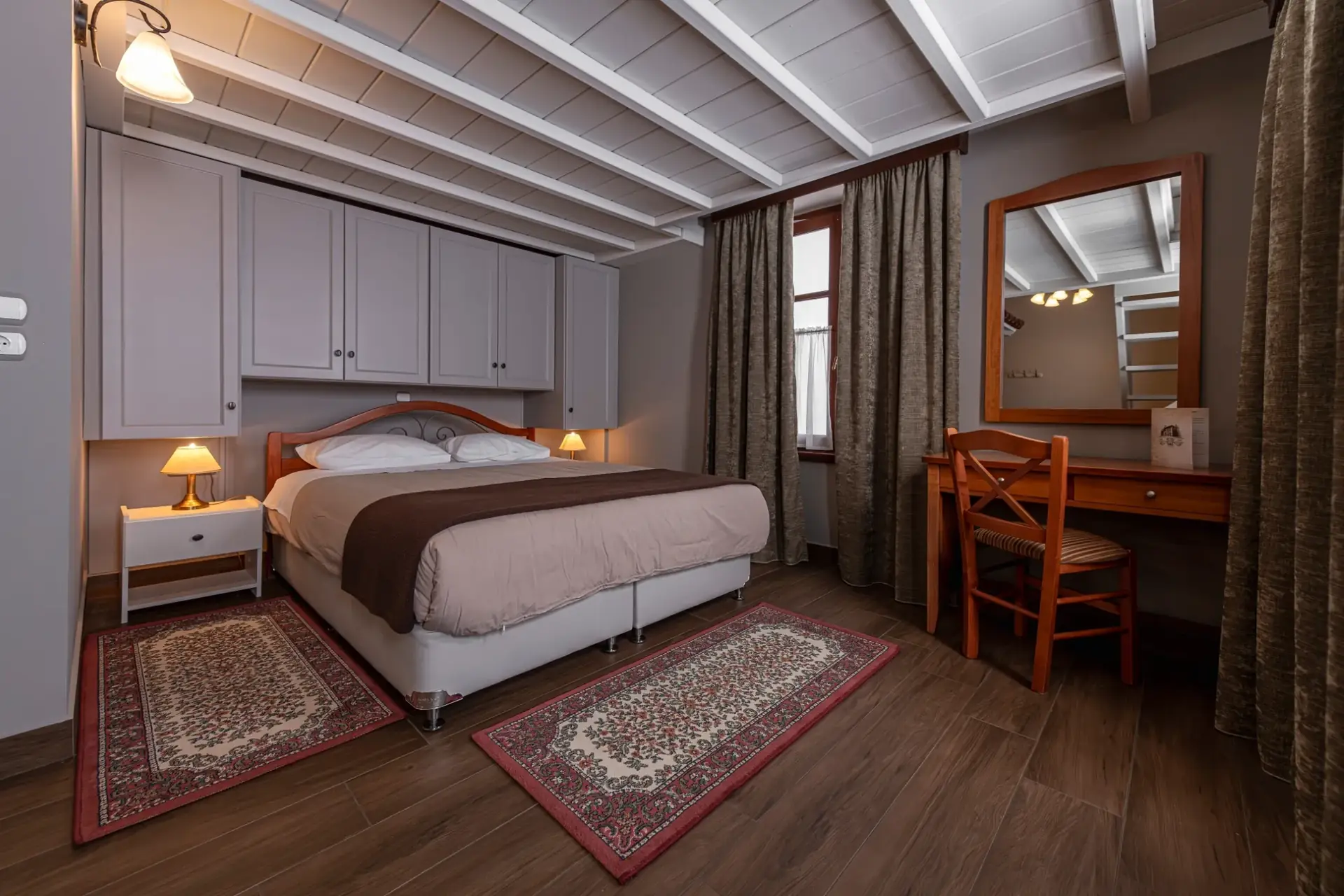 Bedroom with wooden headboard, gray wardrobes and desk