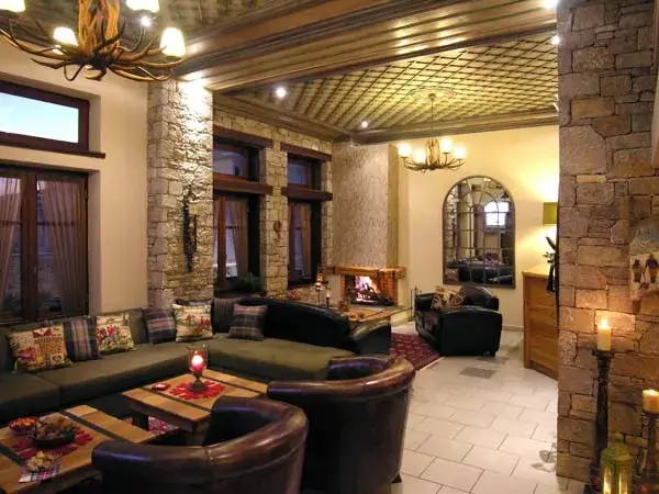 Interior lounge with stone walls, wooden ceiling and chandeliers